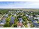 An aerial view of a serene community surrounding a pond with lush trees and attractive homes at 2664 Magnolia Woods Dr, Mount Pleasant, SC 29464
