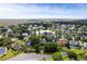 An aerial view of a neighborhood with pond, trees, and marsh in the background at 2664 Magnolia Woods Dr, Mount Pleasant, SC 29464