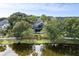An aerial view showcases the home's backyard pool, large lot, and lush greenery at 2664 Magnolia Woods Dr, Mount Pleasant, SC 29464