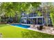 A backyard featuring a pool, a fire pit, a patio with a chair, a yard and second story deck with furniture at 2664 Magnolia Woods Dr, Mount Pleasant, SC 29464