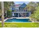Relax in your private backyard oasis with a sparkling pool, lush landscaping, and screened porch at 2664 Magnolia Woods Dr, Mount Pleasant, SC 29464