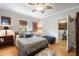 Comfortable bedroom with a bed, natural light, and view into a workout room for a healthy lifestyle at 2664 Magnolia Woods Dr, Mount Pleasant, SC 29464