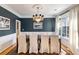 Elegant dining room with a dark accent wall, hardwood floors, and a chandelier above the table at 2664 Magnolia Woods Dr, Mount Pleasant, SC 29464