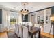 Elegant dining room with a dark accent wall, hardwood floors, and a chandelier above the table at 2664 Magnolia Woods Dr, Mount Pleasant, SC 29464
