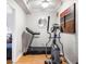 A home gym features a treadmill, elliptical, hardwood floors, and a modern ceiling fan at 2664 Magnolia Woods Dr, Mount Pleasant, SC 29464