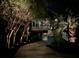 Exterior view of a charming home with lush trees and landscape lighting at 2664 Magnolia Woods Dr, Mount Pleasant, SC 29464
