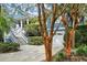 Charming two-story home with a white staircase and a view of the attached garage and landscaped yard at 2664 Magnolia Woods Dr, Mount Pleasant, SC 29464