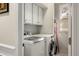 Efficient laundry room featuring a modern washer and dryer, white cabinets, and a window for natural light at 2664 Magnolia Woods Dr, Mount Pleasant, SC 29464