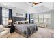 Spacious main bedroom featuring a tray ceiling, natural light, and stylish furnishings at 2664 Magnolia Woods Dr, Mount Pleasant, SC 29464