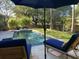 Relaxing poolside view with lounge chairs and a sun umbrella beside the inviting crystal clear swimming pool at 2664 Magnolia Woods Dr, Mount Pleasant, SC 29464