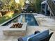 Inviting backyard featuring a pristine pool, a cozy fire pit, and outdoor seating for relaxation at 2664 Magnolia Woods Dr, Mount Pleasant, SC 29464