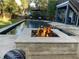 Outdoor living space highlighting a modern pool and fire pit for ultimate relaxation and entertainment at 2664 Magnolia Woods Dr, Mount Pleasant, SC 29464