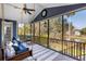 Relax on this screened porch with a hanging swing bed, seating and views of the outdoors at 2664 Magnolia Woods Dr, Mount Pleasant, SC 29464