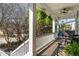 Covered porch with swing, fan, plants, and white pillars and railings, offering a relaxing outdoor space at 2664 Magnolia Woods Dr, Mount Pleasant, SC 29464