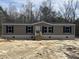 Charming one-story home with tan siding, black shutters, and a neatly maintained front yard, awaiting landscaping at 286 Marion Rd, Dorchester, SC 29437