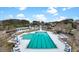 Aerial view of a large community pool area with chairs, tables, and umbrellas for residents to enjoy at 2876 Rivertowne Pkwy, Mount Pleasant, SC 29466