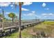 Picturesque wooden dock extending over the marshland, offering access to waterfront activities and beautiful views at 2876 Rivertowne Pkwy, Mount Pleasant, SC 29466