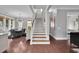 Inviting entryway with hardwood floors, staircase, and open view to the dining and living areas at 2876 Rivertowne Pkwy, Mount Pleasant, SC 29466