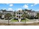 Charming yellow two-story home featuring double porches, nice landscaping, and a picket fence at 2876 Rivertowne Pkwy, Mount Pleasant, SC 29466