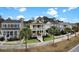 Beautiful yellow two-story home featuring double porches and manicured landscaping at 2876 Rivertowne Pkwy, Mount Pleasant, SC 29466