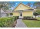 Charming yellow cottage with inviting brick path and manicured hedges at 2876 Rivertowne Pkwy, Mount Pleasant, SC 29466