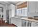 Bright kitchen features stainless steel appliances, white cabinets, and a large window at 2876 Rivertowne Pkwy, Mount Pleasant, SC 29466
