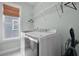 Bright laundry room with front load washer and dryer and shelving at 2876 Rivertowne Pkwy, Mount Pleasant, SC 29466