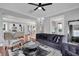Open-concept living room with hardwood floors, neutral paint, and seamless flow to the kitchen at 2876 Rivertowne Pkwy, Mount Pleasant, SC 29466