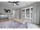 Bedroom featuring ample natural light, a ceiling fan, and mirrored dresser at 2876 Rivertowne Pkwy, Mount Pleasant, SC 29466