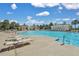 Resort-style pool with lounge chairs, palm trees, and a bath house offering the perfect place to relax and unwind at 2876 Rivertowne Pkwy, Mount Pleasant, SC 29466