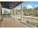 Relaxing covered porch with wood flooring and views of the neighborhood street and lush trees at 2876 Rivertowne Pkwy, Mount Pleasant, SC 29466