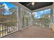 Relaxing covered porch overlooking the landscaped yard at 2876 Rivertowne Pkwy, Mount Pleasant, SC 29466