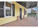 Covered porch showcasing wood flooring, black ceiling, and view of the home's entry at 2876 Rivertowne Pkwy, Mount Pleasant, SC 29466