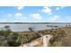 An aerial view of a long pier extending into the water, surrounded by lush greenery and marshland at 2876 Rivertowne Pkwy, Mount Pleasant, SC 29466