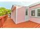 The backyard shows the exterior painted pink, a wooden fence and a patio at 3 25Th Ave, Isle of Palms, SC 29451