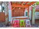 Outdoor bar featuring a corrugated metal roof, string lights, and colorful stools at 3 25Th Ave, Isle of Palms, SC 29451