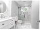 Bright bathroom with a glass shower door and white marble floors and walls at 3 25Th Ave, Isle of Palms, SC 29451