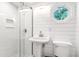 Cozy bathroom featuring shiplap walls, a glass shower, and hexagon shaped window at 3 25Th Ave, Isle of Palms, SC 29451