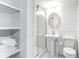 All-white bathroom featuring walk-in shower with glass doors and sleek finishes at 3 25Th Ave, Isle of Palms, SC 29451