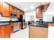Modern kitchen featuring stainless steel appliances, white tile floors, and custom wood cabinets at 3 25Th Ave, Isle of Palms, SC 29451