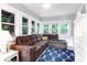 Bright living room with a plush sectional sofa, white trim, and lots of windows at 3 25Th Ave, Isle of Palms, SC 29451