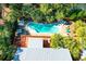 Aerial view of a kidney-shaped pool with lounge chairs, set amongst lush palm trees at 3 25Th Ave, Isle of Palms, SC 29451