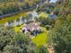 Stunning aerial view of a home next to a beautiful pond surrounded by lush greenery at 4105 Gnarled Oaks Ln, Johns Island, SC 29455