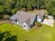 Magnificent aerial view of a well-manicured lawn and a spacious home with a covered porch at 4105 Gnarled Oaks Ln, Johns Island, SC 29455