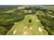 Aerial view of a meticulously designed golf course surrounded by beautiful waterways and verdant forests at 4105 Gnarled Oaks Ln, Johns Island, SC 29455
