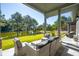 Covered back porch features comfortable seating and scenic views of the lake and trees at 4105 Gnarled Oaks Ln, Johns Island, SC 29455