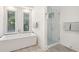 White bathroom featuring a soaking tub, walk-in shower, and bright natural light at 4105 Gnarled Oaks Ln, Johns Island, SC 29455