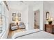 Inviting bedroom with comfortable seating area, hardwood floors, and access to an adjoining space at 4105 Gnarled Oaks Ln, Johns Island, SC 29455