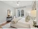 Serene bedroom featuring a large window, light walls, wooden floors, and a comfortable bed at 4105 Gnarled Oaks Ln, Johns Island, SC 29455