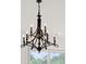 Close-up of an ornate chandelier illuminating the space with its elegant design and soft lighting at 4105 Gnarled Oaks Ln, Johns Island, SC 29455